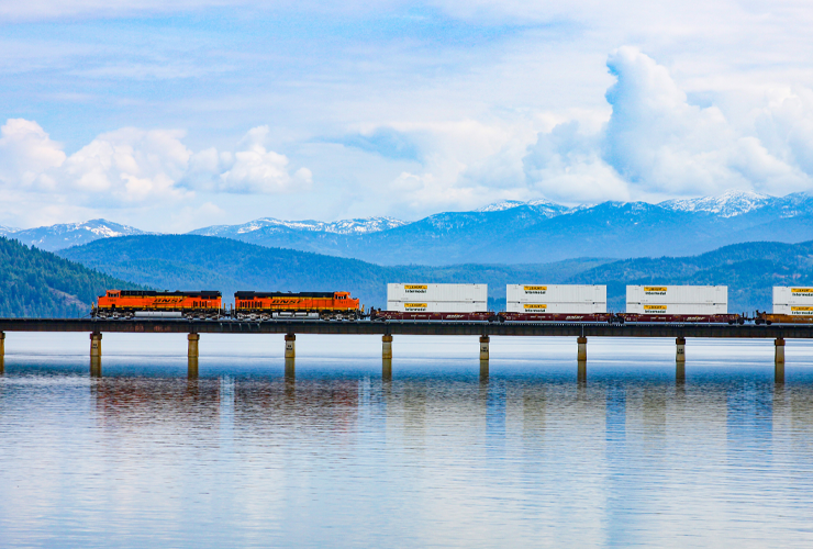 BNSF train shipping J.B. Hunt intermodal containers across a bridge