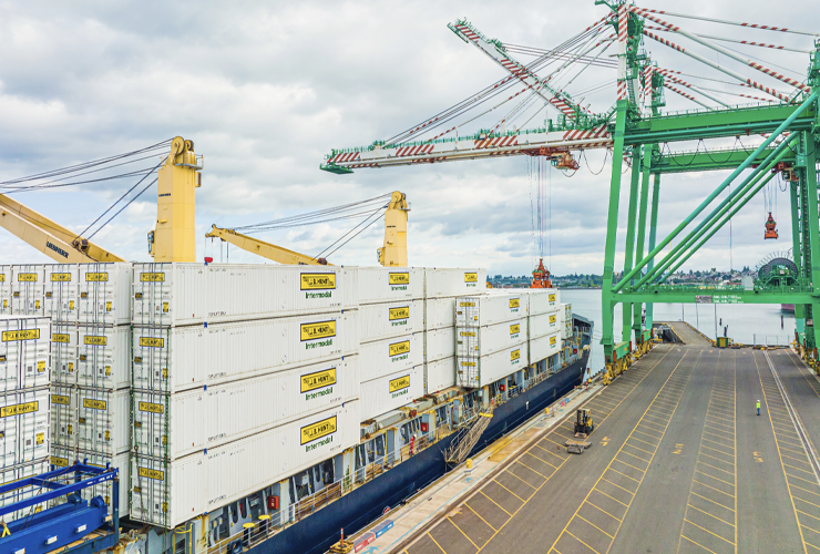 J.B. Hunt Intermodal containers on a ship next to a loading dock