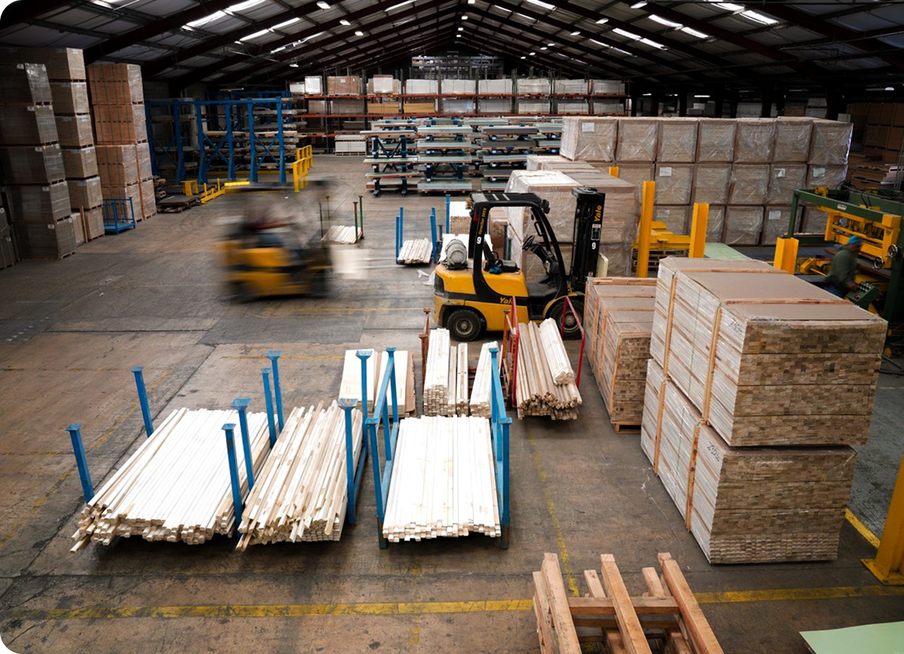 aerial view of a warehouse with forklifts working in the background