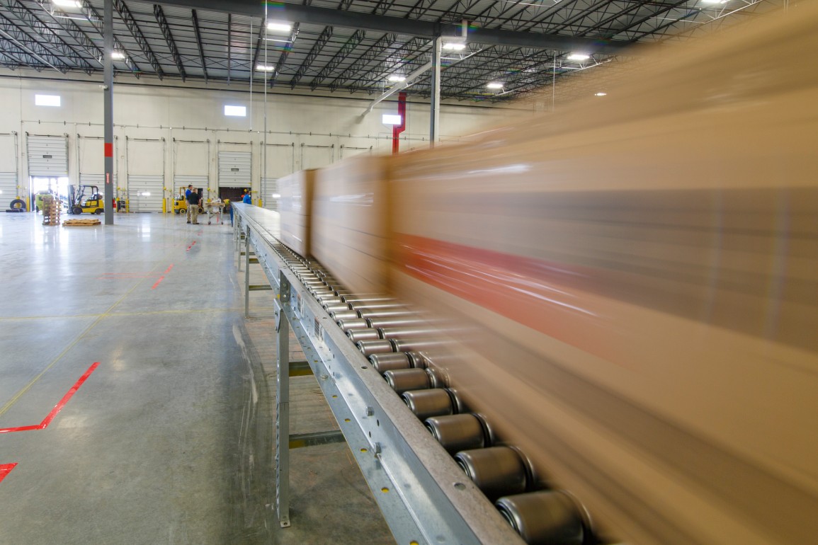 boxes traveling on a conveyor belt in a warehouse