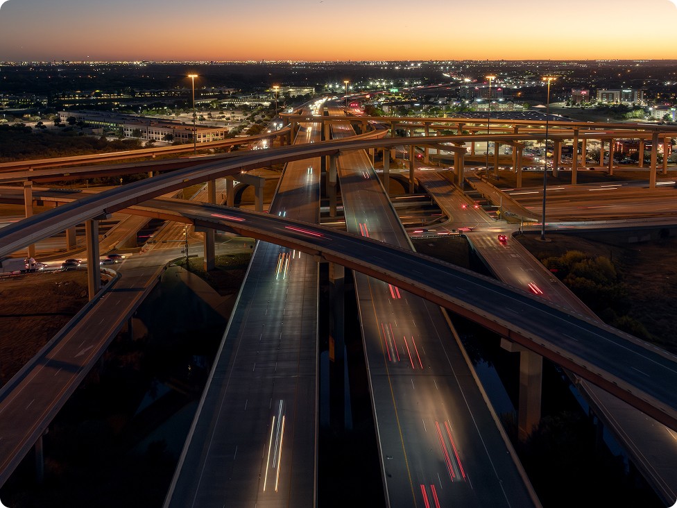 Drone timelapse shot of a highway overpass near sunset 