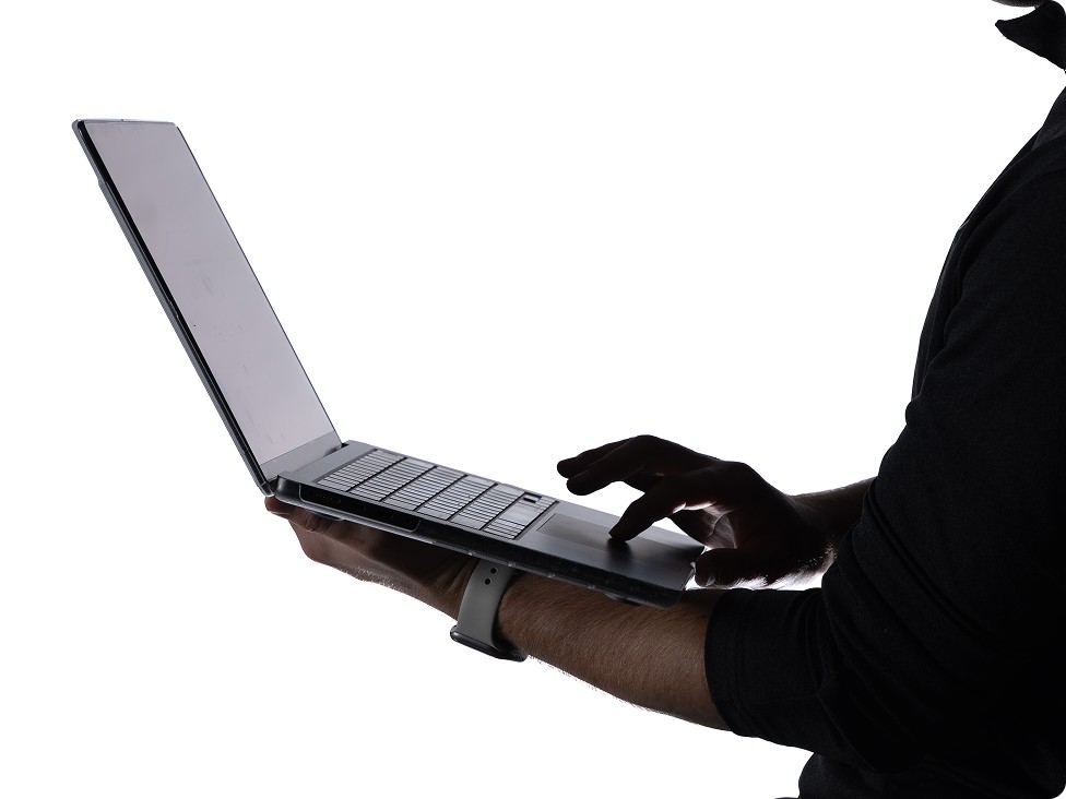 silhouette of user holding a laptop