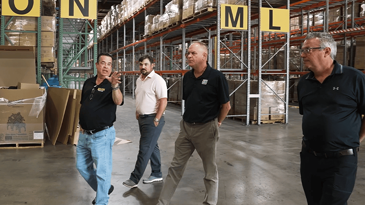 Individuals touring a warehouse